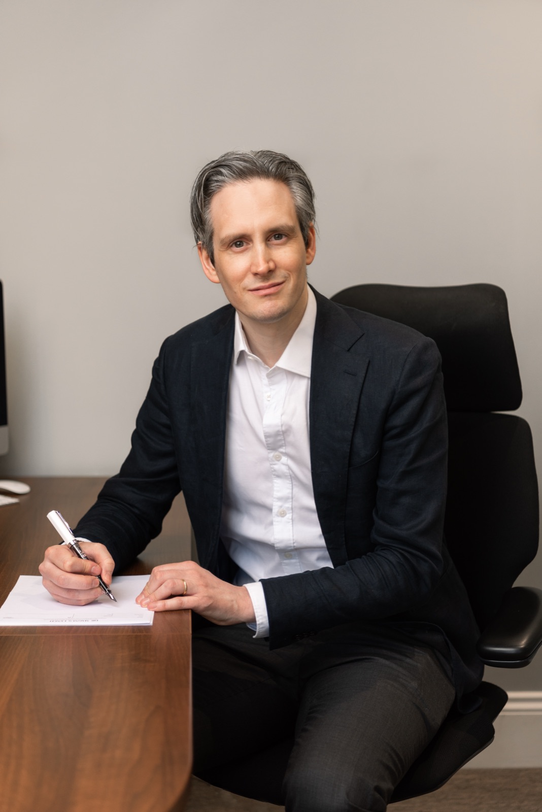 Dr Magnus Lynch, Consultant Dermatologist, at his consulting desk